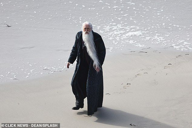 The actor was a far cry from the wizarding school Hogwarts as he was spotted filming on the sandy beach in Cornwall