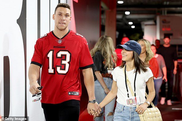Pictured: Judge wears a Tampa Bay Buccaneers jersey while attending an NFL game with wife Sam