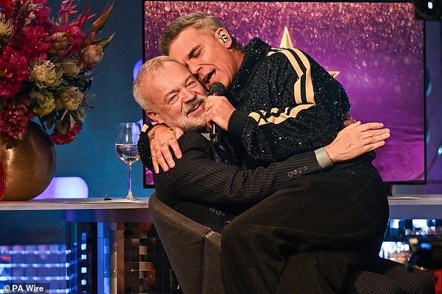 Robbie Williams put on quite the performance as he serenaded the guests and climbed into Graham's lap while belting out his new singlePretty Face