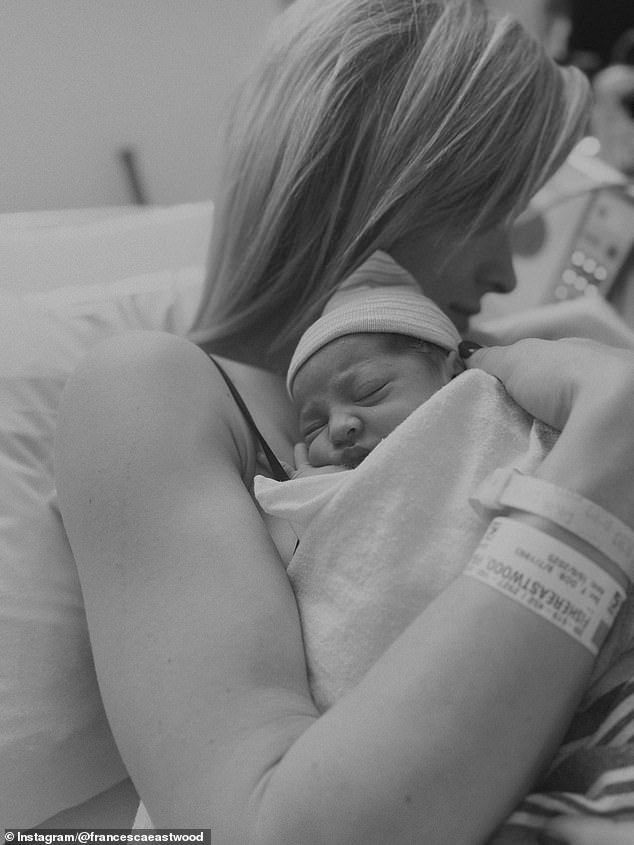 She flashed her wristband as she held the cute baby