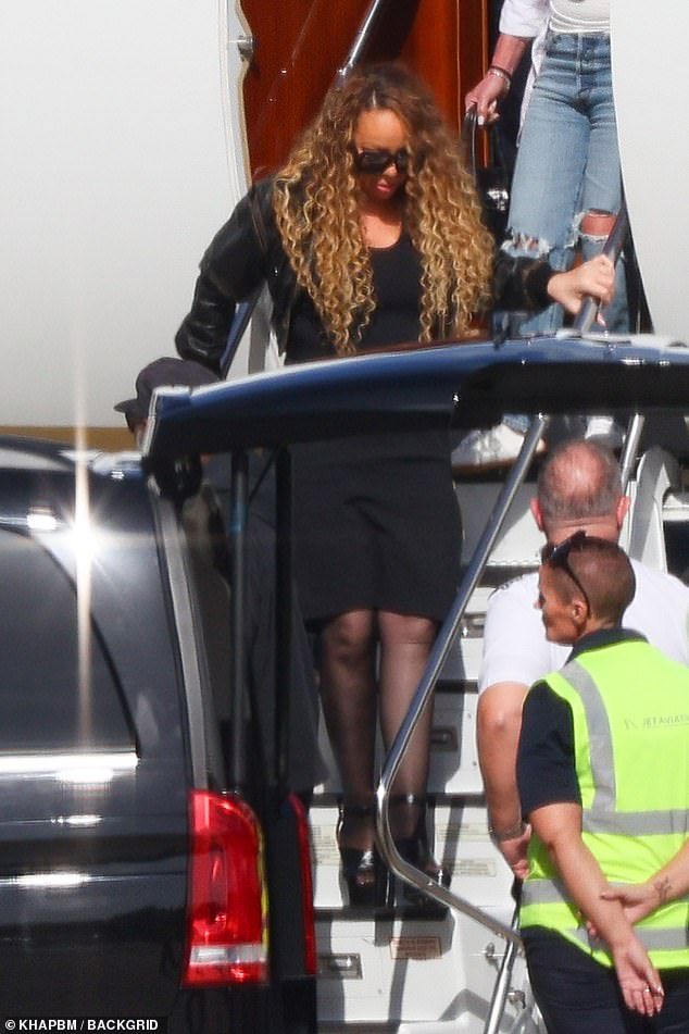 The 56-year-old stepped off her plane looking fabulous in a fitted black dress worn along with a cropped leather jacket