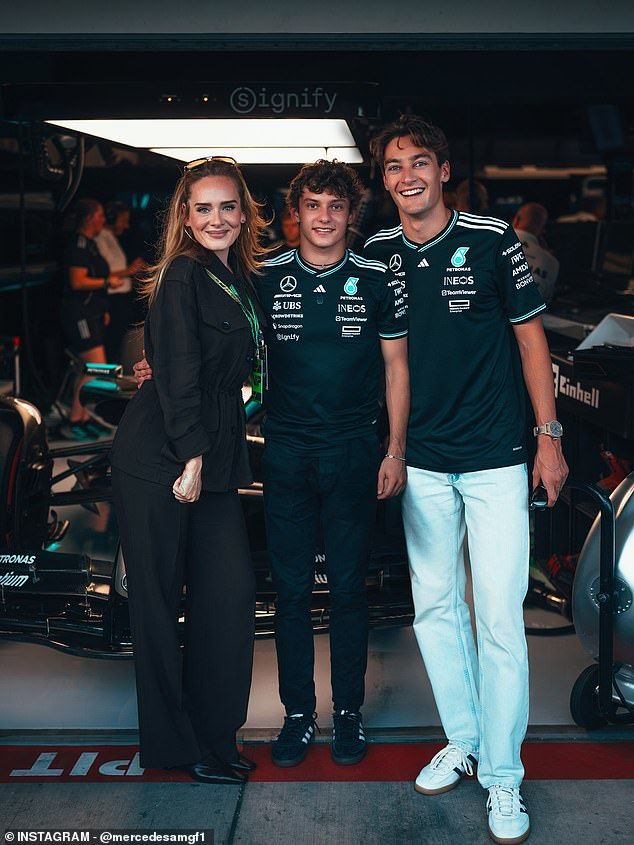 British icon Adele was seen in the pit lane at the US Grand Prix with the Mercedes AMG Formula One team. She snapped a picture with drivers Kimi Antonelli (center) and George Russell (R).