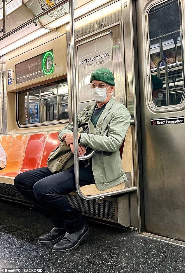 Hanks wore a green jacket with a dark green cardigan, dark trousers, black boots, a green ski cap and clear plastic glasses